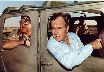 General Norman Schwarzkopf, Jr. and President George H. W. Bush visit US troops in Saudi Arabia in 1990.