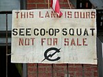 Sign which says "This is our land. See Co-op Squat. Not for sale."