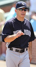 Medium-wide shot of manager Joe Girardi with a "NEW YORK" shirt and "NY" hat.