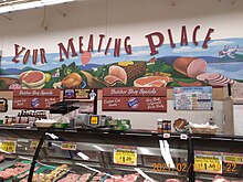 A display of Karns' meat selection, titled "Your Meating Place". With plenty of fresh cut meat products in a display case.