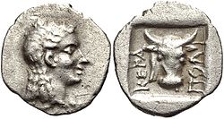 Obol from Ceramus. It has the head of the god Apollo and a Bucranium, 2 BC.
