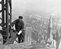 Image 5A workman helps raise the Empire State Building 25 floors higher than the Chrysler Building (at right), as seen in 1931. (from History of New York City (1898–1945))