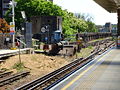 Southern end of the platforms at Putney Bridge station, showing the reversing siding, the World War 2 pillbox defending the bridge, and the northern tip of the bridge