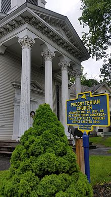 a picture of the marker with the church behind it