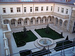 Courtyard (curtains and chandeliers are visible in all windows)