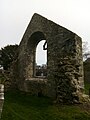 Ruined medieval church, with tracery fragment visible in the windowframe