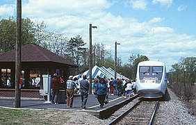 A silver passenger trainset with "Amtrak" written below the cab windows