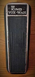 A color image of a 1968 King Vox Wah pedal. The foot pedal is black with chrome accents and has a "King Vox Wah" label on the top.