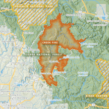 The footprint of the Creek Fire is shown in orange, and is shaped roughly like a crescent arc, with several protrusions, between Yosemite National Park to the north and Kings Canyon National Park to the south. A finger of the fire reaches out toward Mammoth Lakes, and another toward Lake Thomas A Edison. Fresno lies in the map's southwest corner.