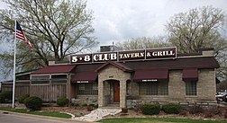 A freestanding one-story restaurant with a sign for "5-8 Club Tavern & Grill"