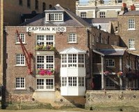 Brown building with white windows and the pub name in all black capital letters.