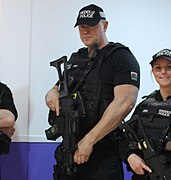 Baseball caps of North Wales Police displaying the word POLICE in English and Welsh