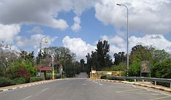 Entrance gate with a wood-carved street plan