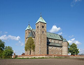 Tum Collegiate Church, Poland, restored after much damage, has small round towers flanking the eastern apses.