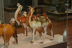 Camels made of brown and green glazed earthenware.