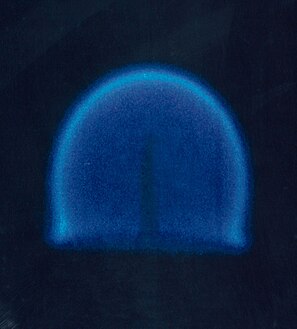 A candle in a microgravity environment. This is a rare example of a diffusion flame which does not produce much soot and does not therefore have a typical yellow flame