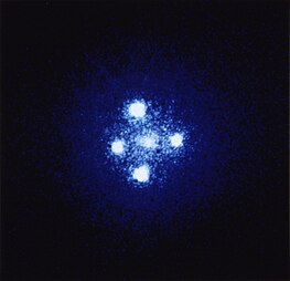 Five balls of light are arranged in a cross shape.