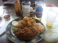 Bahamian peas n' rice served with cracked conch and coleslaw.