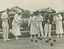 Black and white photo of male and female lawn bowlers