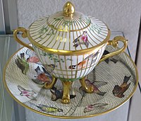 Vienna cup with cover, birds in nets and cages.