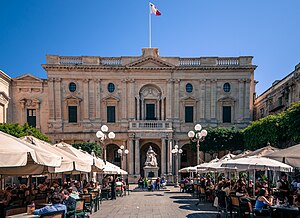 Republic Square Valletta Malta, 2014. Various tent-covered tables line a pathway to the front of the Bibliotheca and its statue.