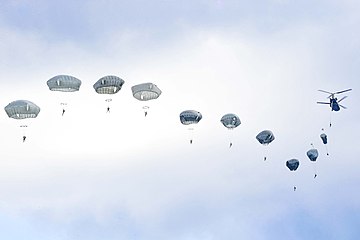 US parachutists jump from a Chinook over Germany in 2019.