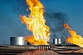 Tanks and burning oil fumes in Fahud. Oman, 1972