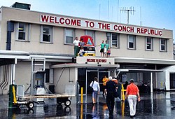 The sign "WELCOME TO THE CONCH REPUBLIC" greets those arriving at Key West International Airport.