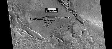 View of stress cracks and larger cracks that have been enlarged by sublimation (ice changing directly into gas). This may be the start of ribbed terrain.