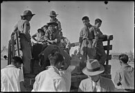 Granada Relocation Center Boy Scouts help with the check baggage in September 1943