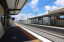 The platforms at a train station showing the footbridge