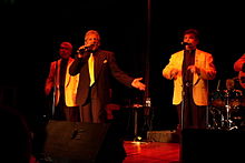 Johnny Maestro (center) with Freddy Ferrara (left) and Les Cauchi (right) of Johnny Maestro & the Brooklyn Bridge at a 2006 show