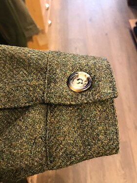 An example of the cuff of a tweed Teba, with the horn button variety.