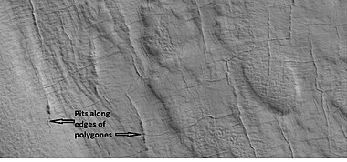 Close-up of pits forming along the edges of polygons in patterned ground, as seen by HiRISE under the HiWish program. Resolution is about 30 cm, so one could see a kitchen table if it were in the picture.