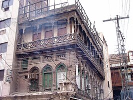 Some buildings in the old city feature carved wooden balconies.