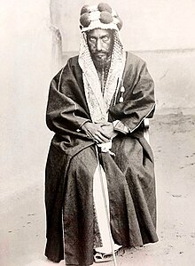 A photograph of Abdul Rahman bin Faisal seated and dressed in traditional Arabian clothing