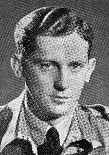 A head and shoulders photograph of a clean shaven man in uniform