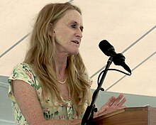 Photo of woman standing behind a podium