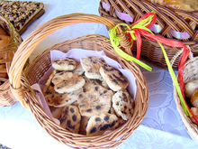 basket filled with round, flat pieces of bread with some browning and charring on the surface