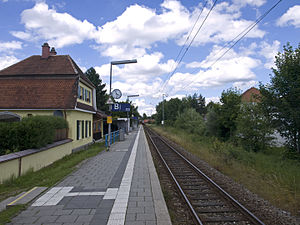 Two-story building next to side platform