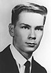 A black and white headshot of LaPointe in a suit and tie