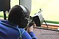 A junior shooter in Switzerland target shoots with a SIG 550. A brass catcher is fitted to avoid disturbing other shooters with the ejection.