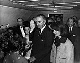Lyndon B. Johnson taking the oath of office aboard Air Force One