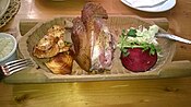Ham hock (golonka) with grilled oscypek, horseradish and a slice of beetroot in Poland