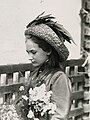 A young Elizabeth Harrison holding Flowers