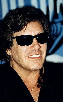 A portrait photograph of Feliciano wearing sunglasses