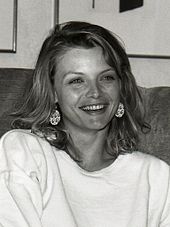 Black-and-white photo of a smiling Michelle Pfeiffer
