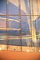 The balconies are reflected in the window facing the fjord