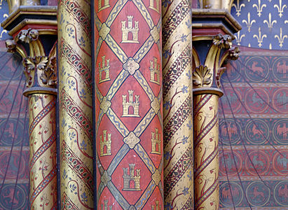 Wall decoration, with fleur-de-lis in the background, and the castle symbol of the Kingdom of Castile in the foreground. Throughout the chapel, symbols of fleur-de-lis and castles are found repeatedly, in a nod to Louis IX's royal heritage (the fleur-de-lis of the French Capet family through his father, Louis VIII, and the castle of the royal Spanish Castile family, the royal heritage of his mother, Blanche of Castile).