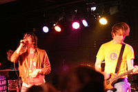 The band Plain White T's performing onstage, with three of the band's members shown in the photo